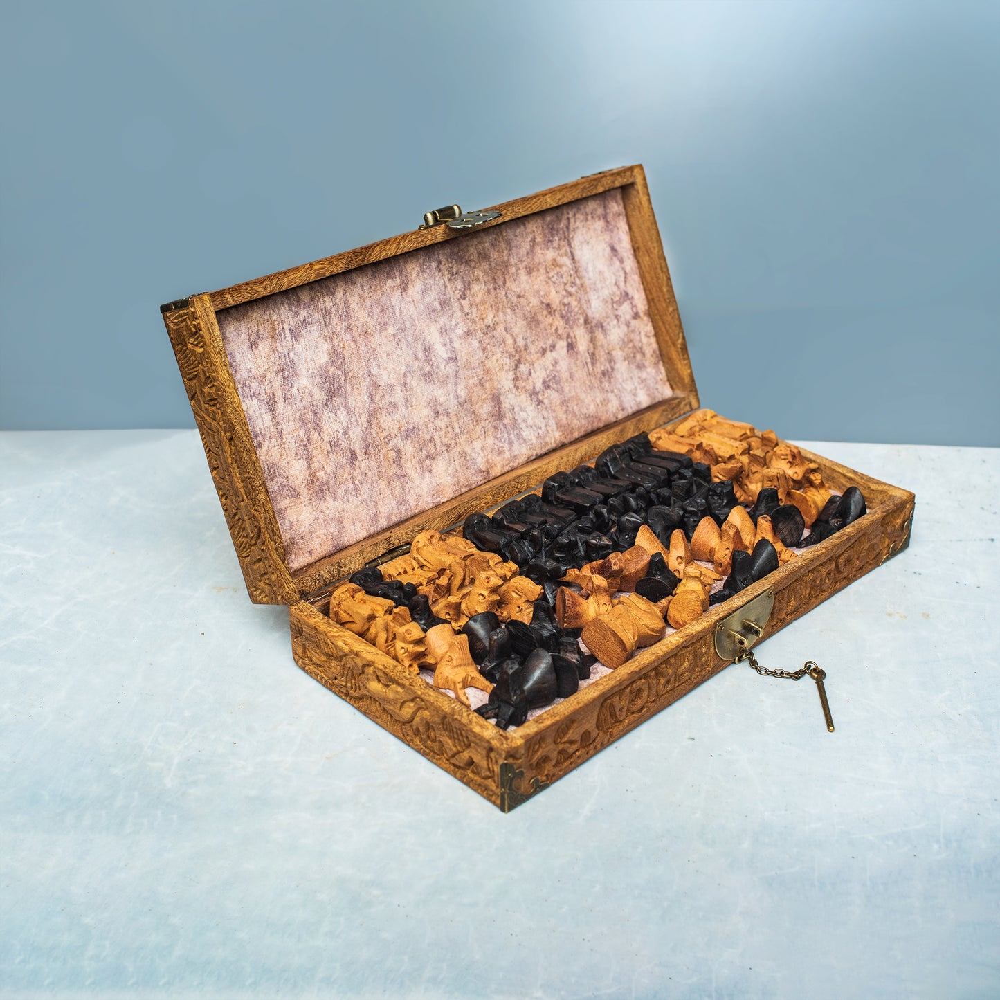 Handmade African chess set displayed on a table, classic wood finish