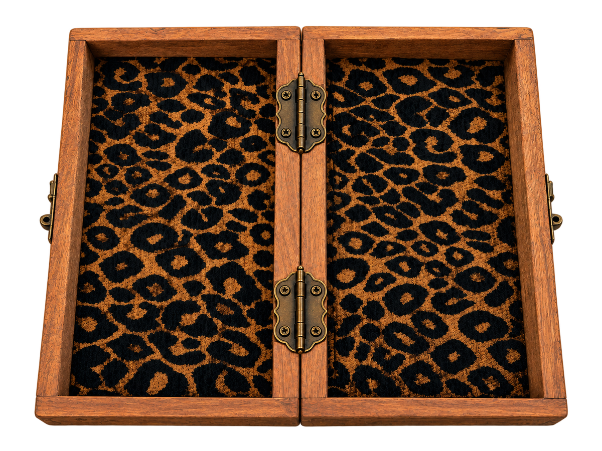 Inside view of a handmade African folding wooden chessboard with built-in chess piece storage, patterned fabric lining and brass hinges.