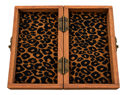 Inside view of a handmade African folding wooden chessboard with built-in chess piece storage, patterned fabric lining and brass hinges.